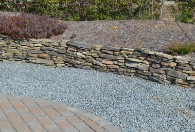 Curved Brick Patio, gravel area and small flatrock retaining wall